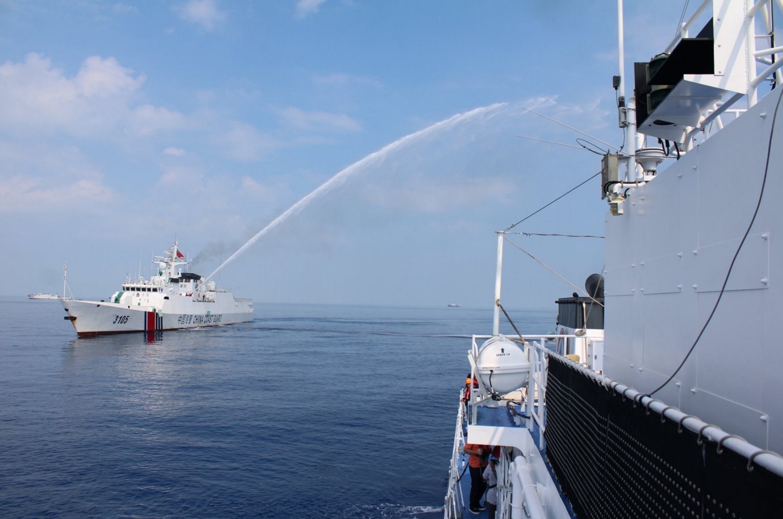A Chinese Coast Guard (CCG) ship firing a water cannon on a Philippine Coast Guard vessel near the Scarborough Shoal, South China Sea, April 30, 2024. (EPA Photo)