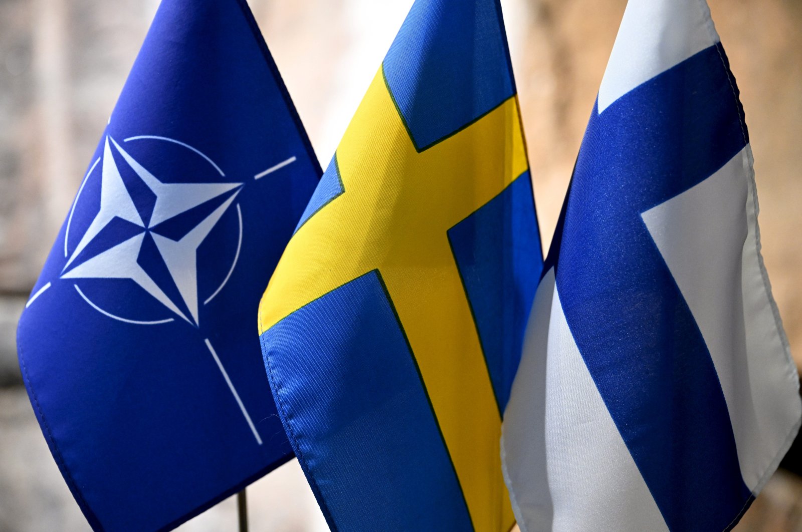 From left, flags of NATO, Sweden and Finland at the event &quot;Finland, Sweden, and Ukraine in an Expanded EU&quot; arranged by Swedish-Finnish Cultural Centre in Espoo, Finland, on March 26, 2024. (Reuters File Photo)