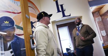 Ron Waddell, founder and executive director of Legendary Legacies, (R) talks with Gary Goyette at the nonprofit organization, Worcester, Mass., U.S., April 19, 2024. (AP Photo)