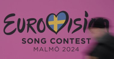 A person walks past a sign for the 2024 Eurovision Song Contest in Malmo, Sweden, April 17, 2024. (Reuters Photo)