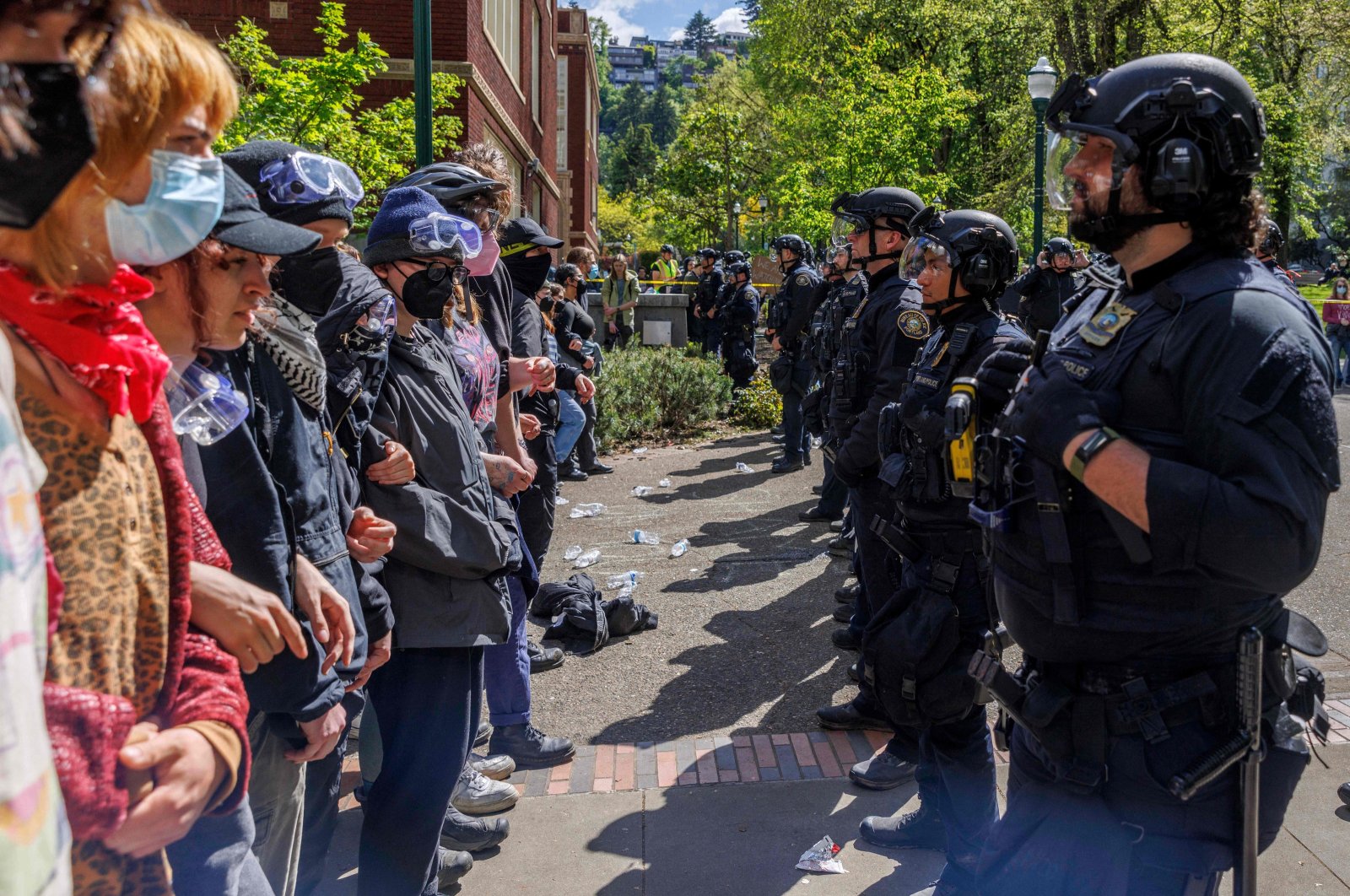 Pro-Palestinian students face police officers after protesters were evicted from the library on campus earlier in the day at Portland State University, Portland, Oregon, U.S., May 2, 2024. (AFP Photo)