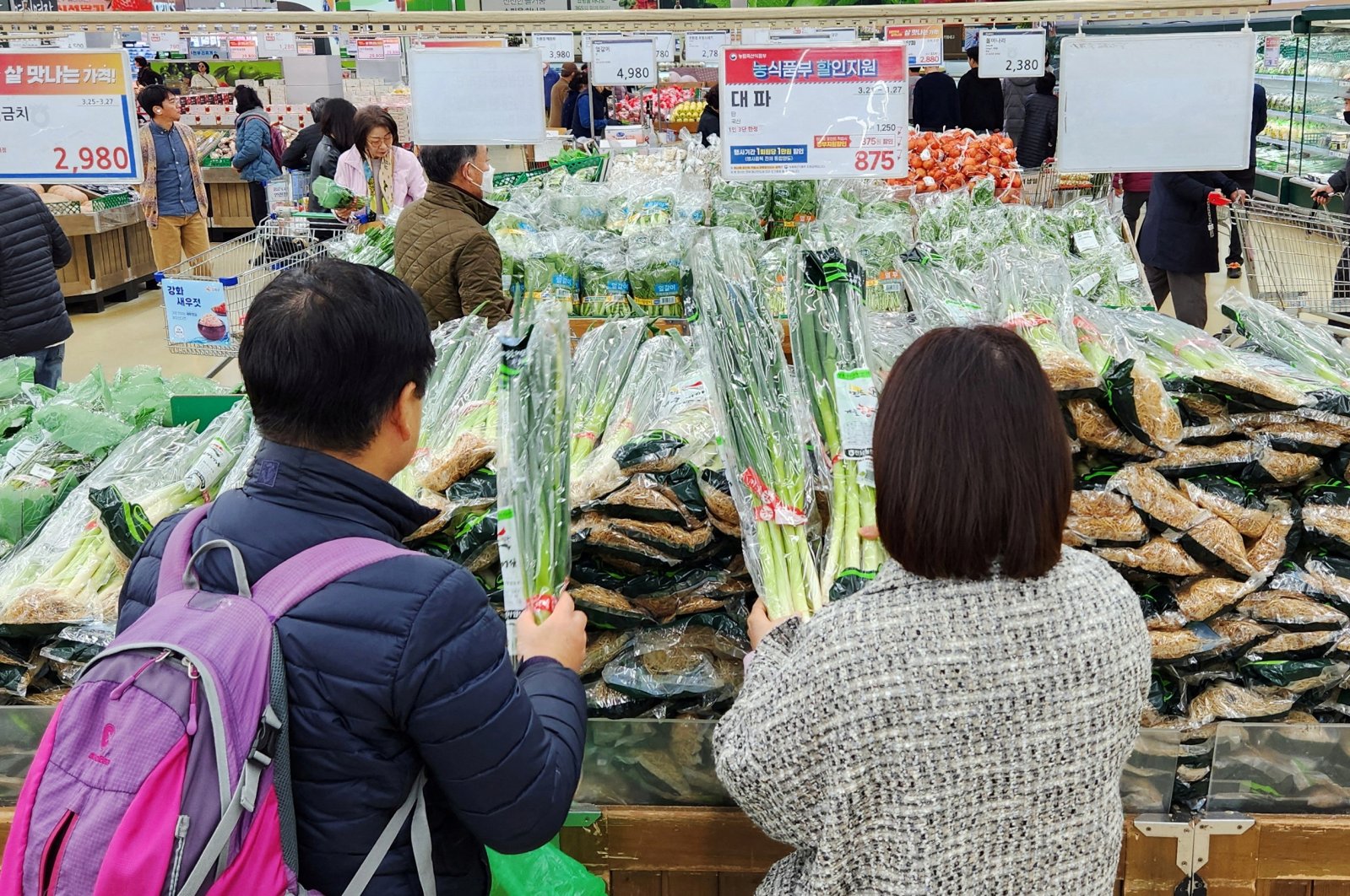 Women shop for green onions at a market in Seoul, South Korea, March 26, 2024. (Reuters Photo)