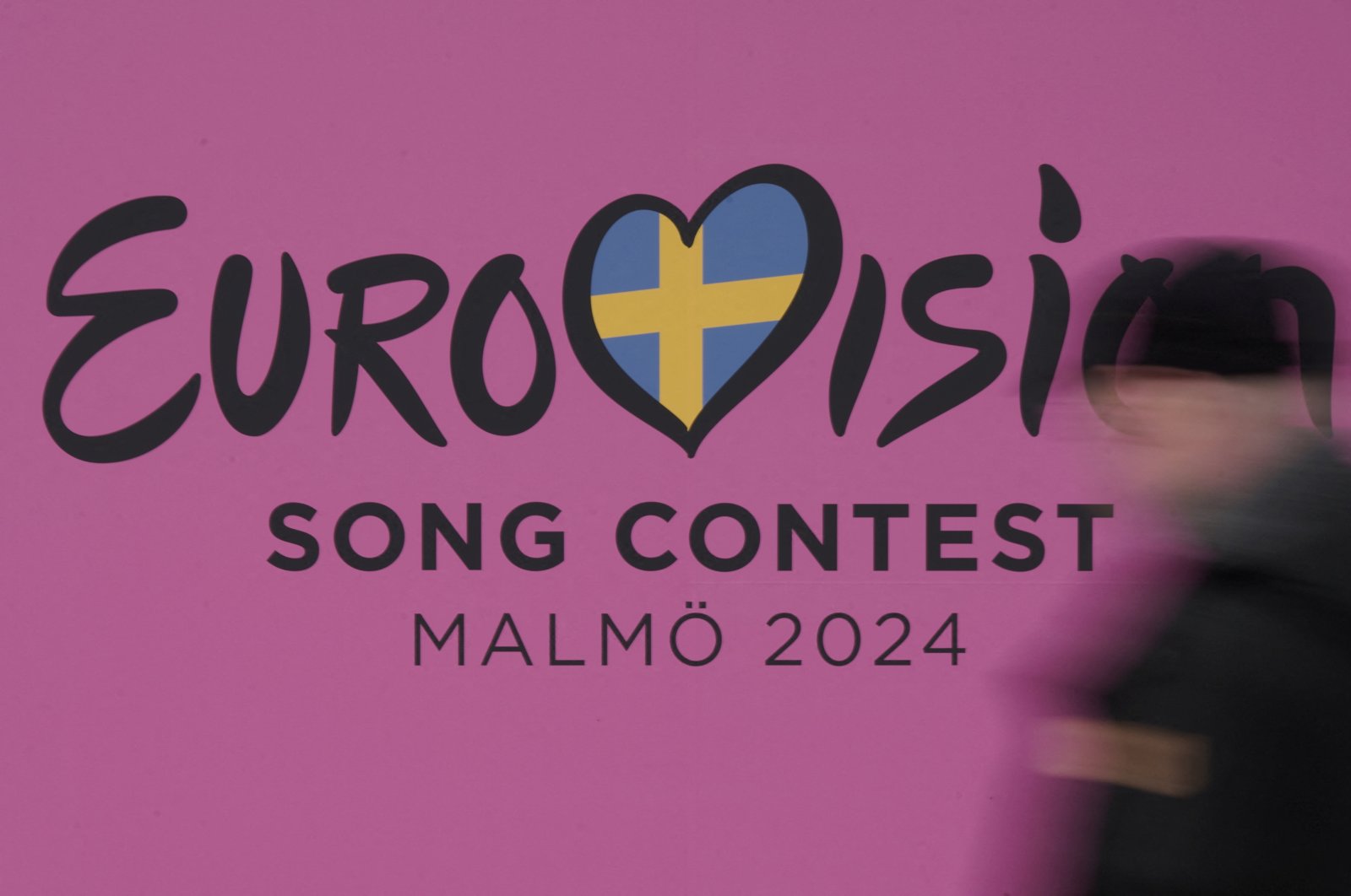 A person walks past a sign for the 2024 Eurovision Song Contest in Malmo, Sweden, April 17, 2024. (Reuters Photo)