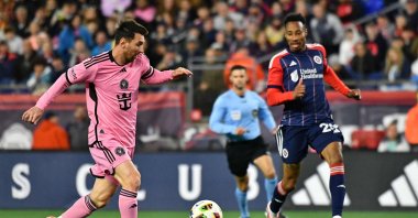 Inter Miami's Lionel Messi (L) fights for the ball with New England Revolution's Mark-Anthony Kaye during the Major League Soccer (MLS) match at Gillette Stadium, Foxborough, Massachusetts, U.S., April 27, 2024. (AFP Photo)