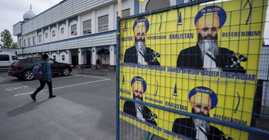 A person walks past signs of Hardeep Singh Nijjar at the Guru Nanak Sikh Gurdwara in Surrey, B.C., Canada, May 3, 2024. (AP Photo)