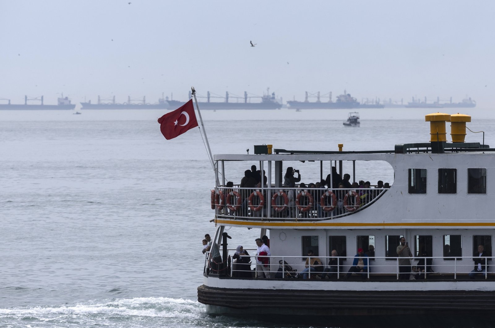 A Turkish ferry sails as cargo ships (back) cross the Bosporus, Istanbul, Türkiye, May 3, 2024. (EPA Photo)