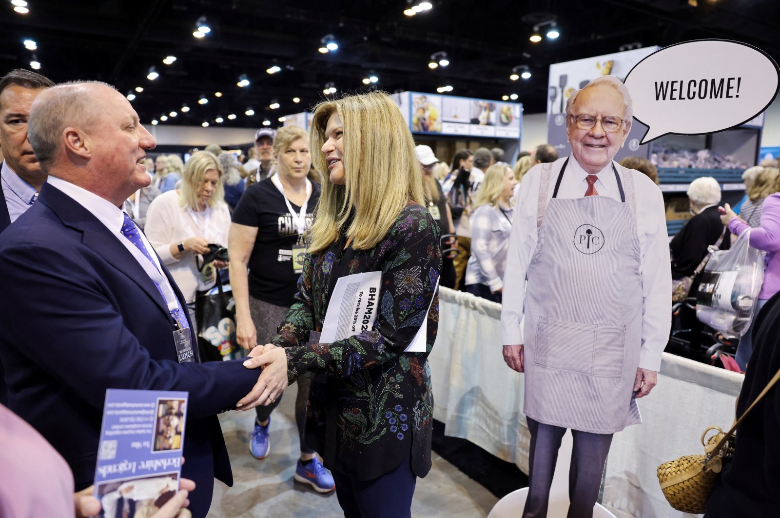 Gregory Abel, Vice Chairman overseeing non-insurance operations for Berkshire Hathaway, talks with Pampered Chef CEO Nevena Srebreva next to a cutout picture of Berkshire Hathaway Chairman Warren Buffett welcoming shareholders to shop at the Pampered Chef booth during the Berkshire Hathaway Inc. annual shareholders&#039; meeting in Omaha, Nebraska, U.S., May 3, 2024. (Reuters Photo)