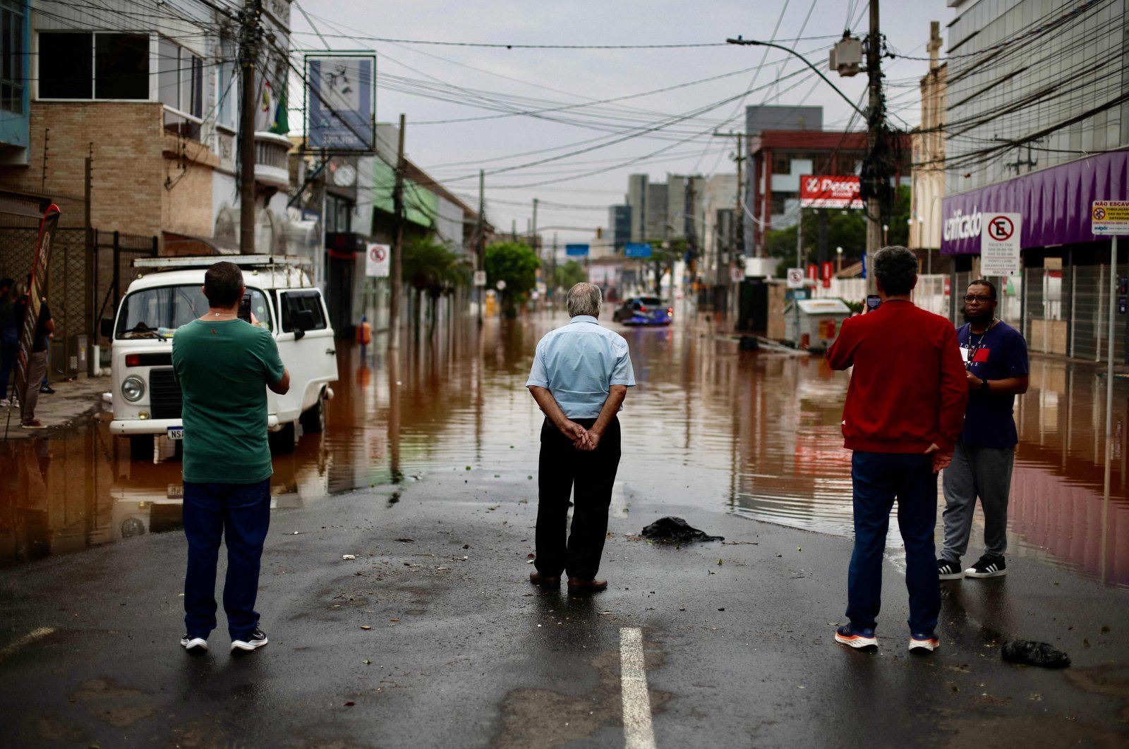 People look at a flooded street in the Sao Geraldo neighborhood in Porto Alegre, Rio Grande do Sul State, Brazil, May 4, 2024. (AFP Photo)
