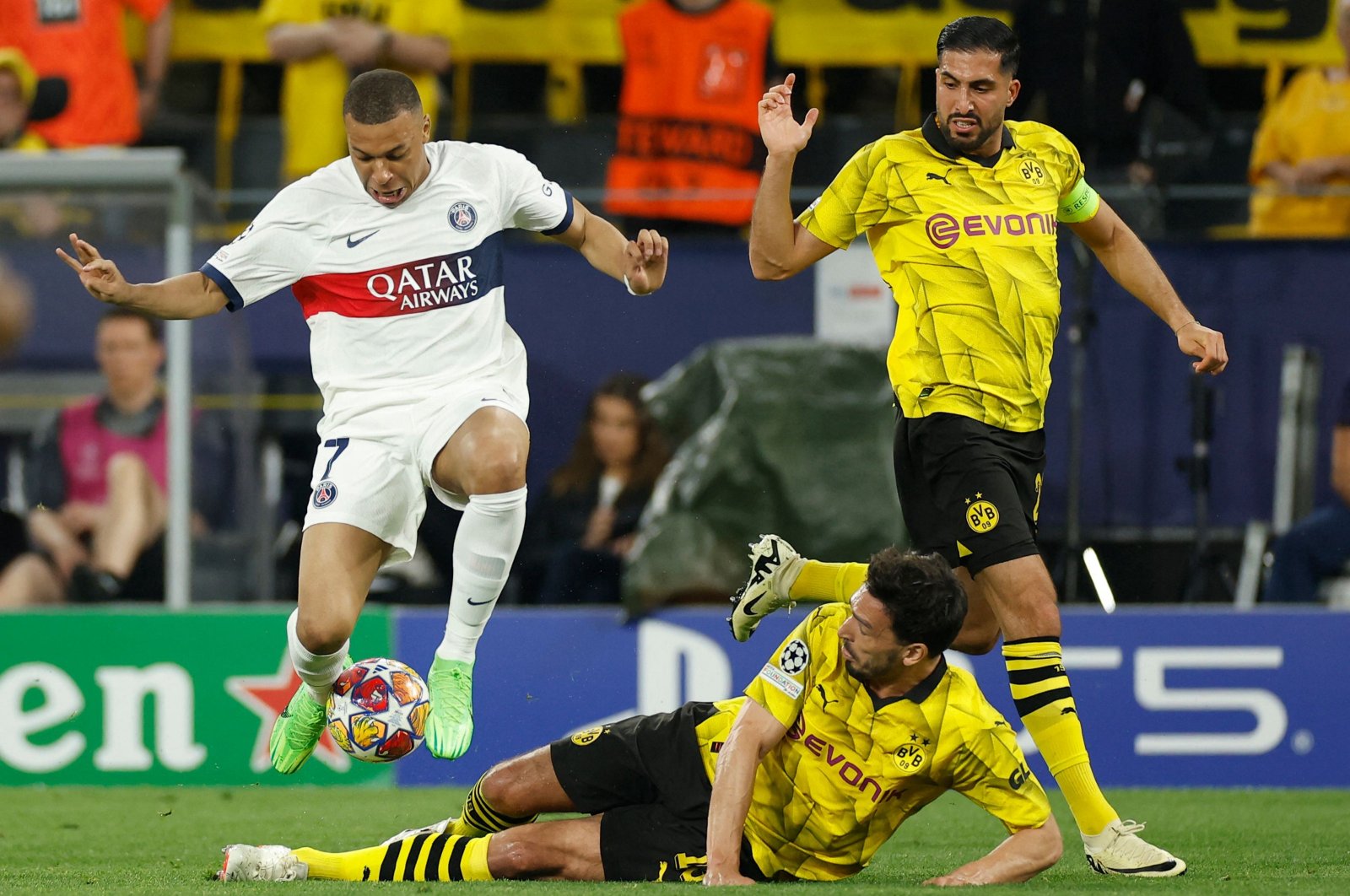 (L-R) Paris Saint-Germain&#039;s Kylian Mbappe, Dortmund&#039;s Mats Hummels and Emre Can vie for the ball during the UEFA Champions League semifinal first leg football match, Dortmund, Germany, May 1, 2024. (AFP Photo)