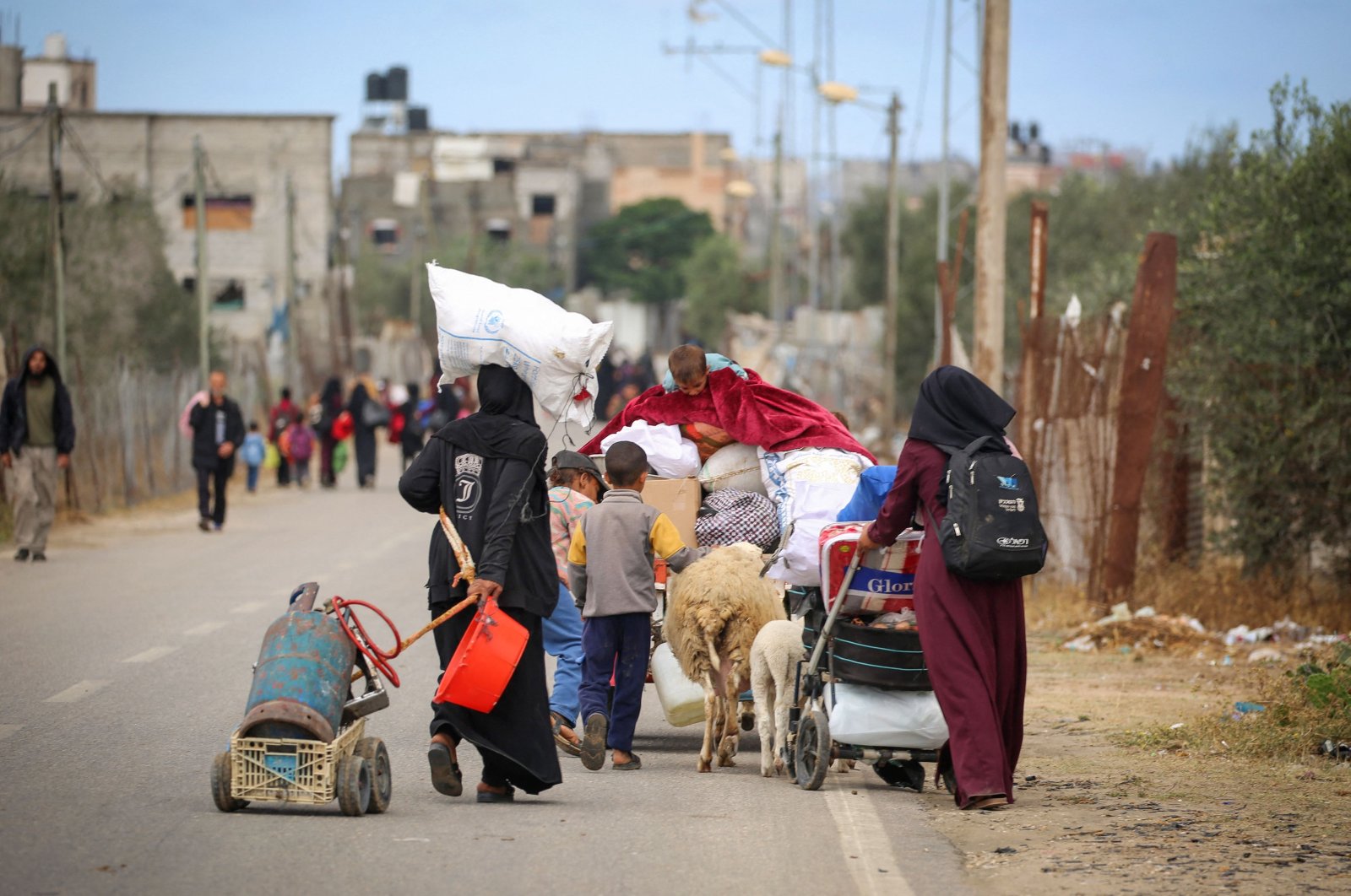 Displaced Palestinians carry their belongings as they leave following an evacuation order by the Israeli army, Rafah, in the southern Gaza Strip, Palestine, May 6, 2024. (AFP Photo)