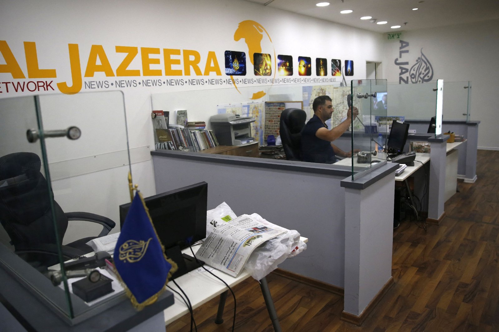  An employee of the Qatar-based news network and TV channel Al-Jazeera is seen at the channel&#039;s Jerusalem office, July 31, 2017. (AFP File Photo)