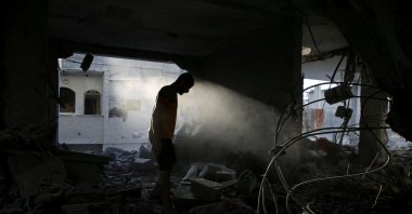 A Palestinian man inspects a house hit in an Israeli strike, amid the ongoing attacks by Israeli forces, Rafah, Gaza Strip, Palestine, May 7, 2024. (Reuters Photo)