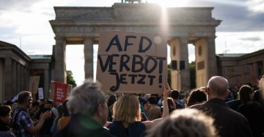 A participant holds a placard reading &quot;AFD ban now!&quot; referring to the far-right Alternative for Germany (AfD) party, during a rally in reaction to attacks on campaigning politicians in Germany, Berlin, Germany, May 5, 2024. (EPA Photo)