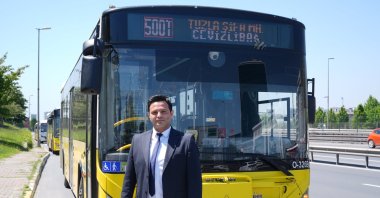 Bus driver Kerem Temur poses in front of a 500T bus in Istanbul, May 7, 2024. (AA Photo)