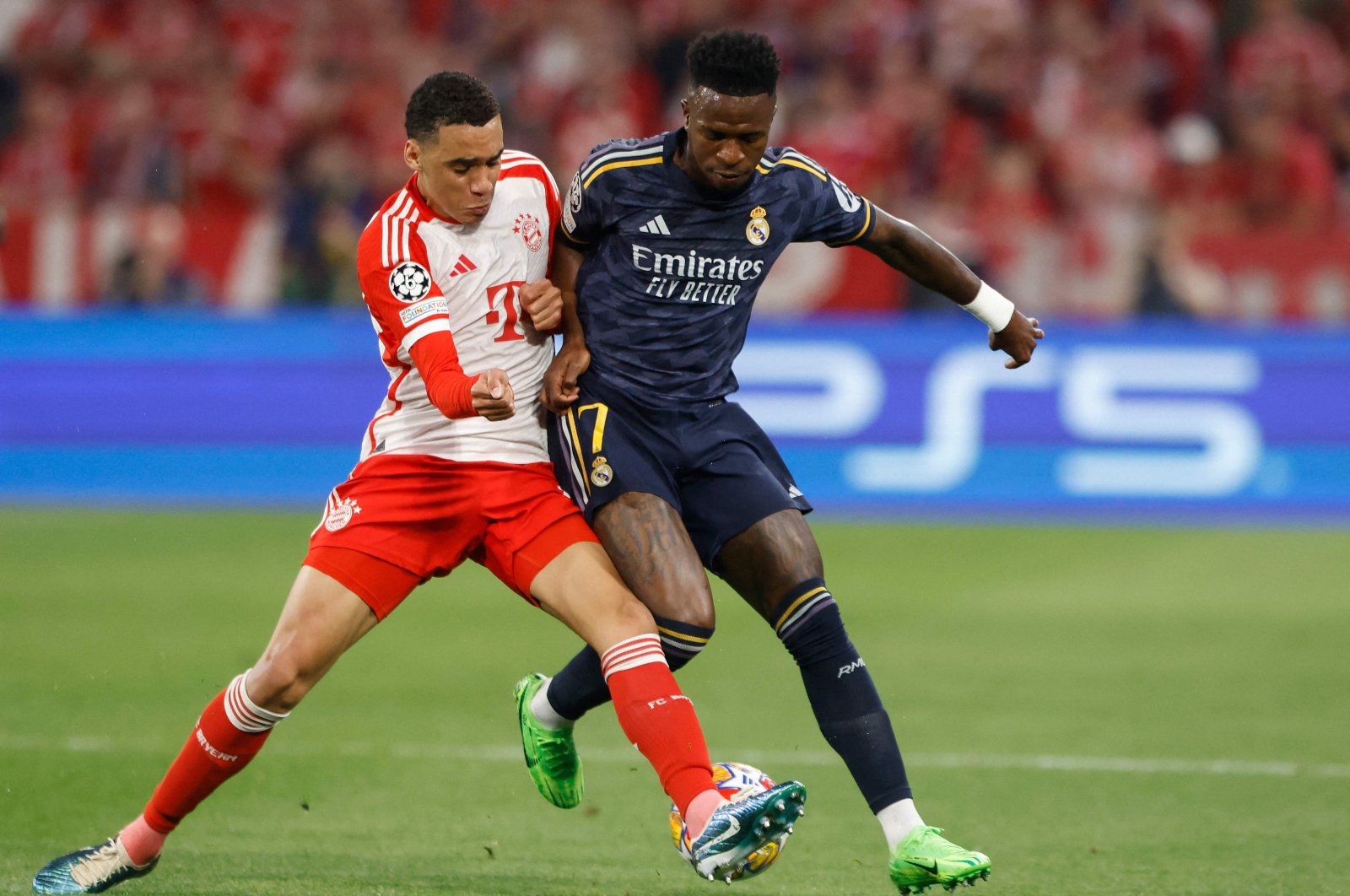 Bayern Munich&#039;s Jamal Musiala (L) and Real Madrid&#039;s Vinicius Junior vie for the ball during the UEFA Champions League semifinal first leg football match, Munich, Germany, April 30, 2024. (AFP Photo)