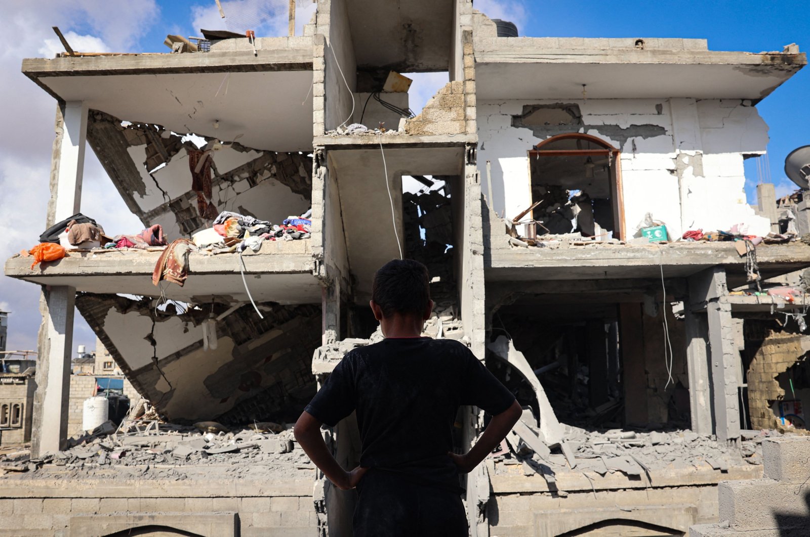 A Palestinian youth stand in front of a destroyed building following Israeli bombardment of Rafah&#039;s Tal al-Sultan district in the southern Gaza Strip, Palestine, May 7, 2024. (AFP Photo)