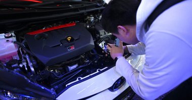 A man checks a Toyota Yaris GR model displayed at the Beijing Auto Show, China, April 25, 2024. (AFP Photo)
