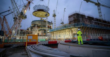 Engineering teams use the world&#039;s largest crane, &quot;Big Carl,&quot; to lift a 245-ton steel dome onto Hinkley Point C&#039;s first reactor building at a nuclear power station construction site, Bridgwater, Somerset, U.K., Dec. 15, 2023. (Reuters Photo)