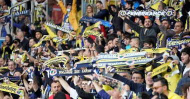 Fenerbahçe supporters raise their flags during the match against Galatasaray at Ülker Stadium, Istanbul, Türkiye, Dec. 24, 2023. (IHA Photo)
