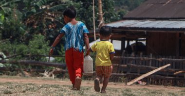 Children carrying a water container between them at a camp for internally displaced people in Demoso township, eastern Kayah state, Myanmar, April 29, 2024. (AFP Photo)