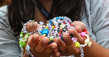 A fan of U.S. singer Taylor Swift, also known as a Swiftie, holds friendship bracelets as she arrives for the first of the pop star's six sold-out Eras Tour concerts at the National Stadium in Singapore, March 2, 2024. (AFP Photo)