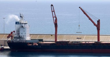 A crane lifts material onto a cargo vessel expected to take aid to Gaza, at the port of Larnaca, Greek Cyprus, May 8, 2024. (Reuters Photo)