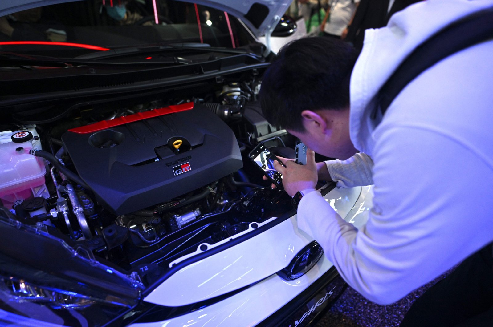 A man checks a Toyota Yaris GR model displayed at the Beijing Auto Show, China, April 25, 2024. (AFP Photo)