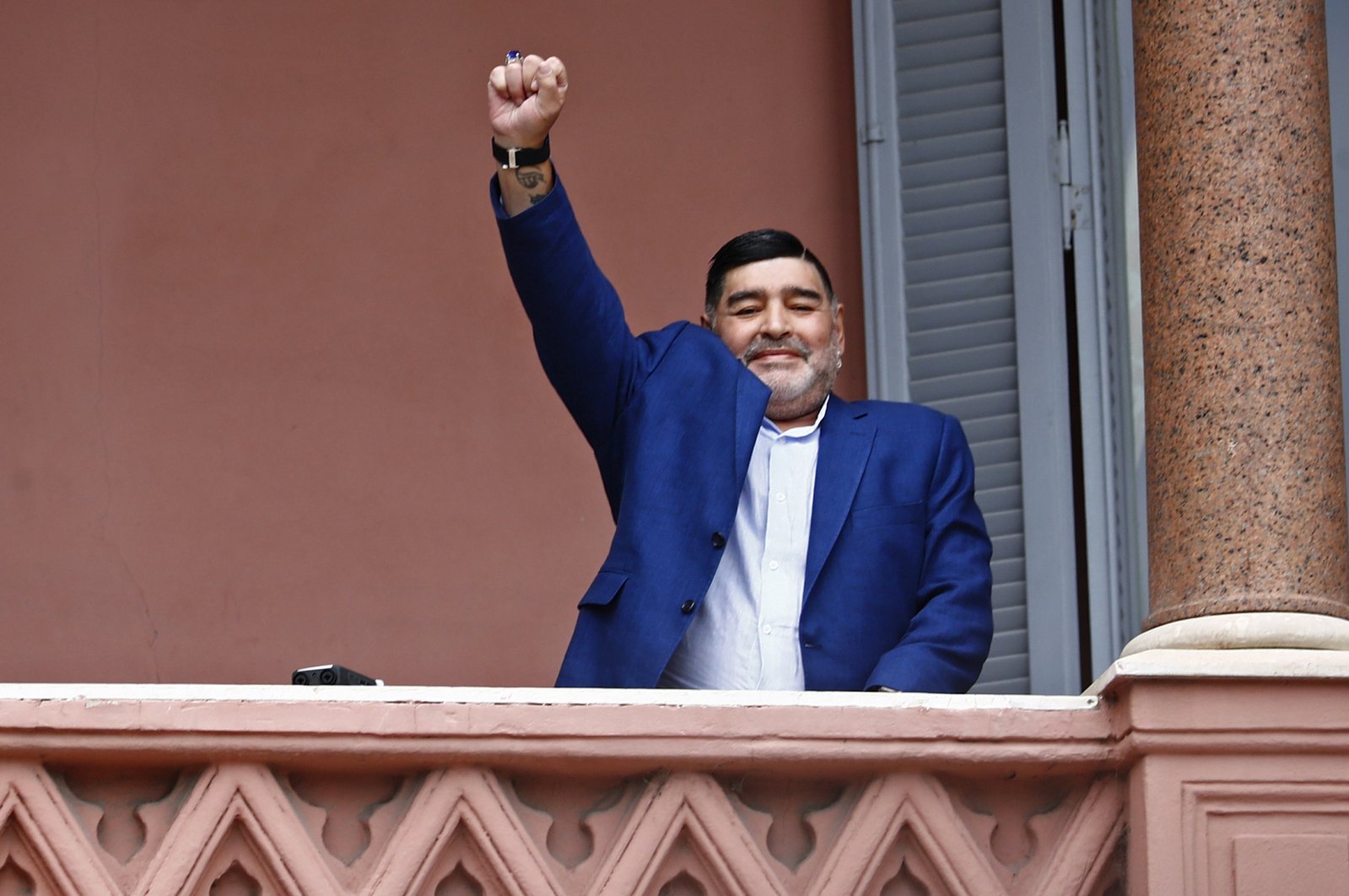 Diego Maradona acknowledges fans below at the Casa Rosada government house after his meeting with Argentine President Alberto Fernandez, Buenos Aires, Argentina, Dec. 26, 2019. (AP Photo)