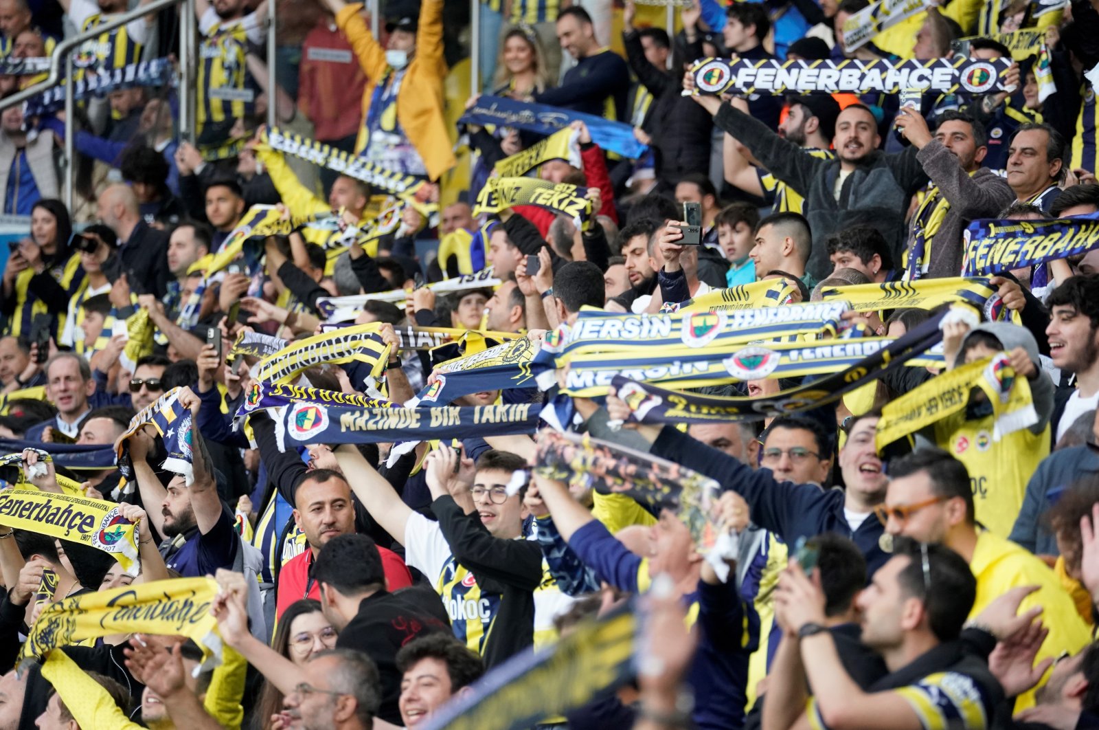 Fenerbahçe supporters raise their flags during the match against Galatasaray at Ülker Stadium, Istanbul, Türkiye, Dec. 24, 2023. (IHA Photo)