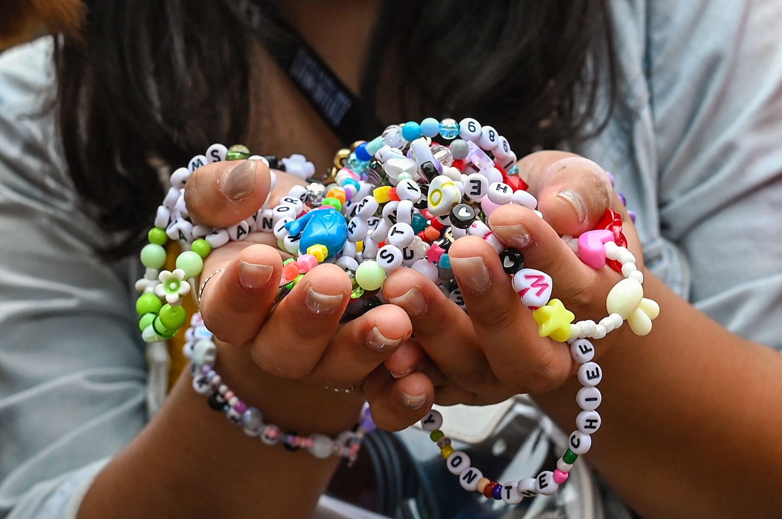 A fan of U.S. singer Taylor Swift, also known as a Swiftie, holds friendship bracelets as she arrives for the first of the pop star&#039;s six sold-out Eras Tour concerts at the National Stadium in Singapore, March 2, 2024. (AFP Photo)