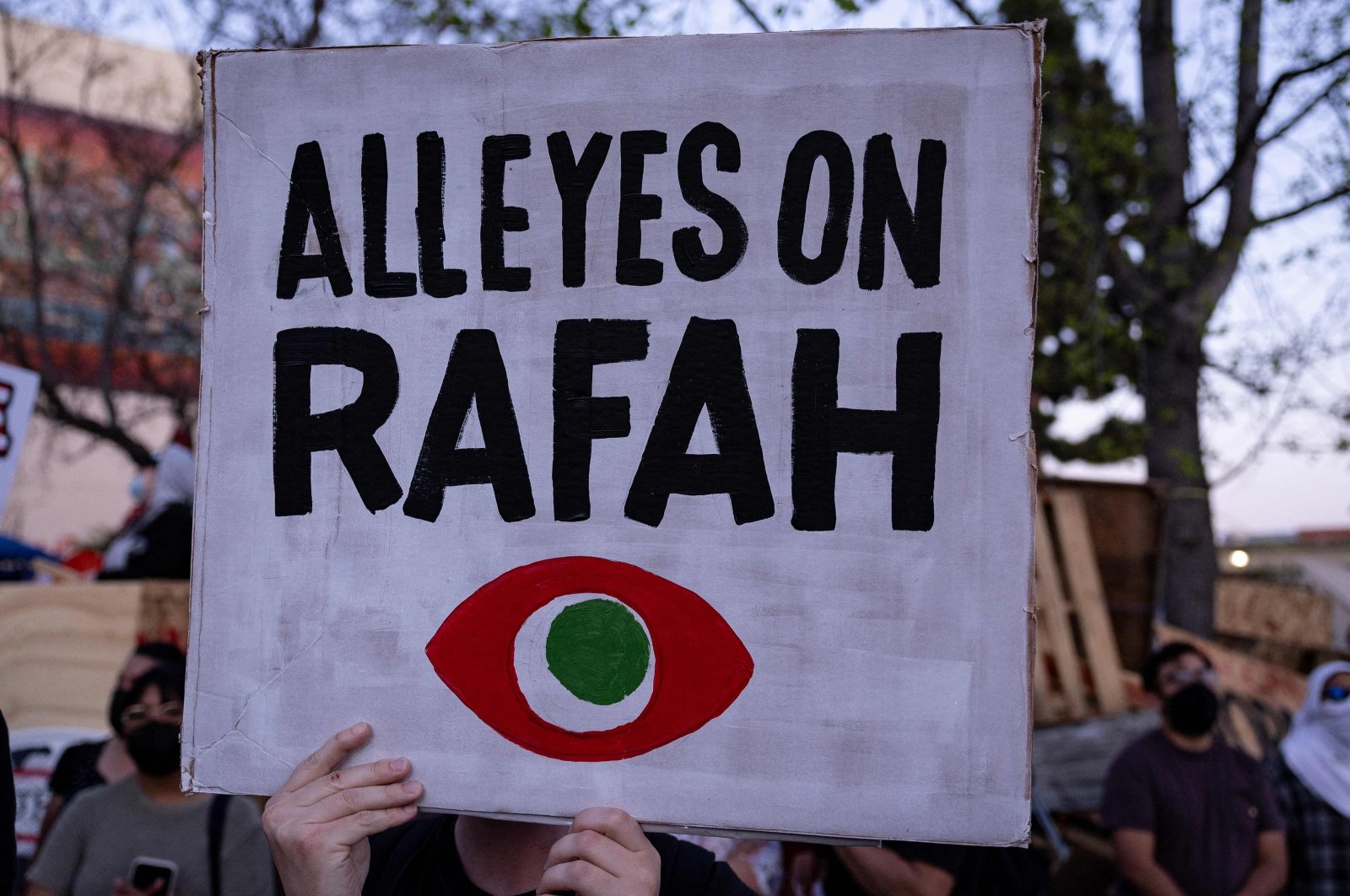 Demonstrators hold signs as they protest during a rally in support of Rafah, next to a pro-Palestinian encampment at California State University, Los Angeles (Cal State LA) in Los Angeles, California, U.S., May 7, 2024. (AFP Photo)