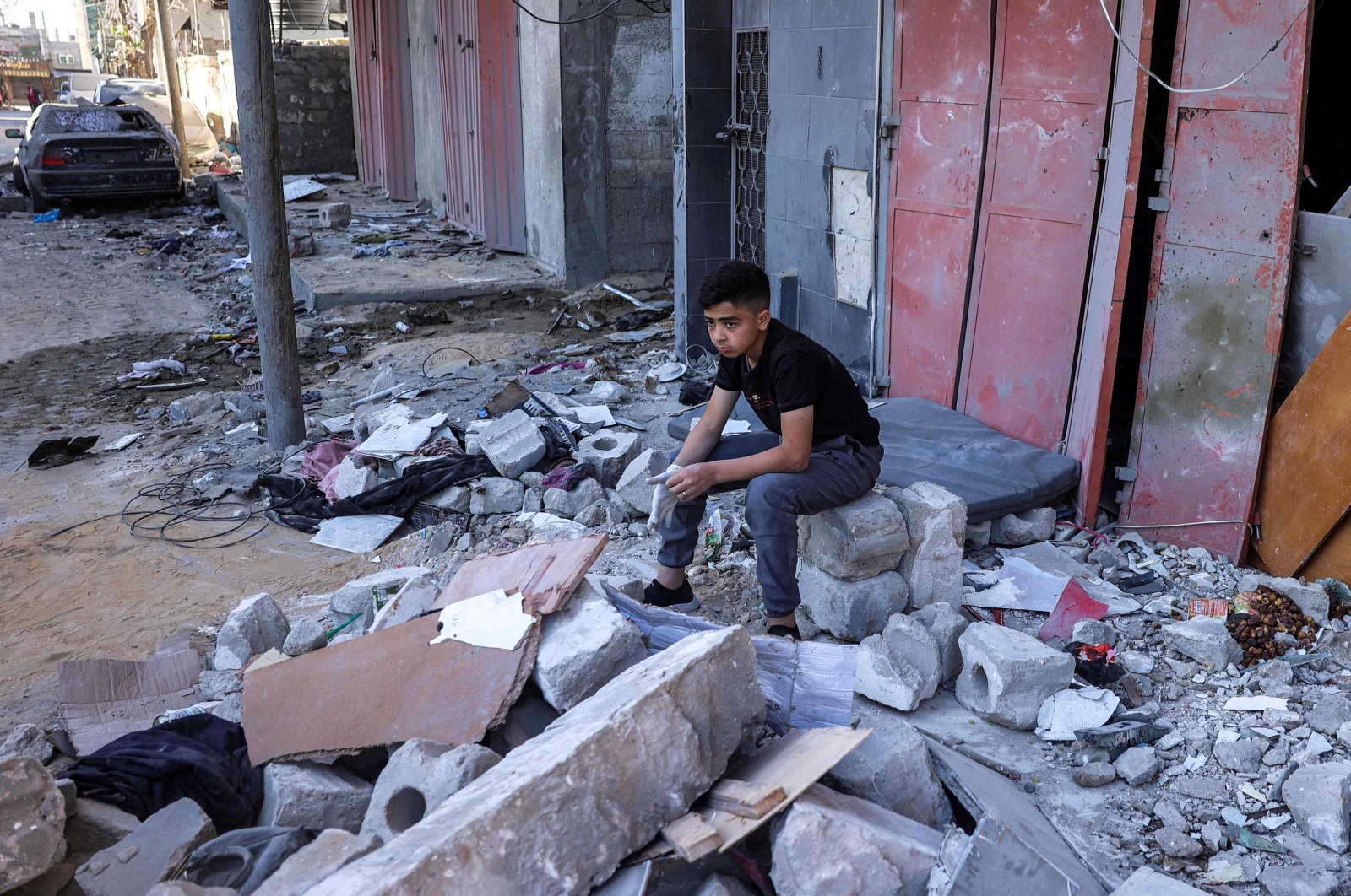 A boy sits amid rubble at the site of a building that was hit by Israeli bombardment in Rafah in the southern Gaza Strip, Palestine, May 8, 2024. (AFP Photo)