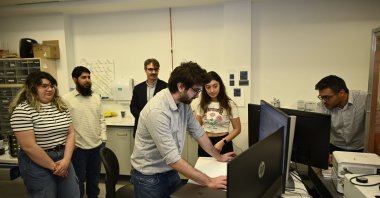 A professor works on device technology developed by researchers at Bilkent University, which swiftly and with high precision detects the environmental and health threats posed by microplastic particles, considered one of the biggest pollutants in the sea, ocean and drinking water, Ankara, Türkiye, March 3, 2024. (AA Photo)