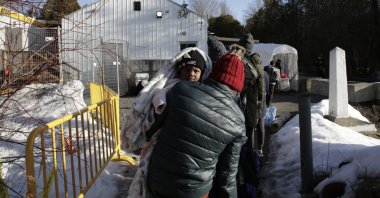 Haitian and Afghani asylum-seekers illegally cross into Canada where police took them into custody at the non-official Roxham Road border crossing, Champlain, New York, March 24, 2023. (AP Photo)