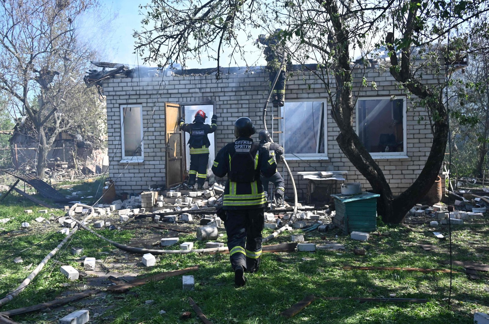 Firefighters put out a fire in a destroyed private house after the explosion of a guided aerial bomb in Kharkiv, Ukraine, May 3, 2024. (AFP Photo)