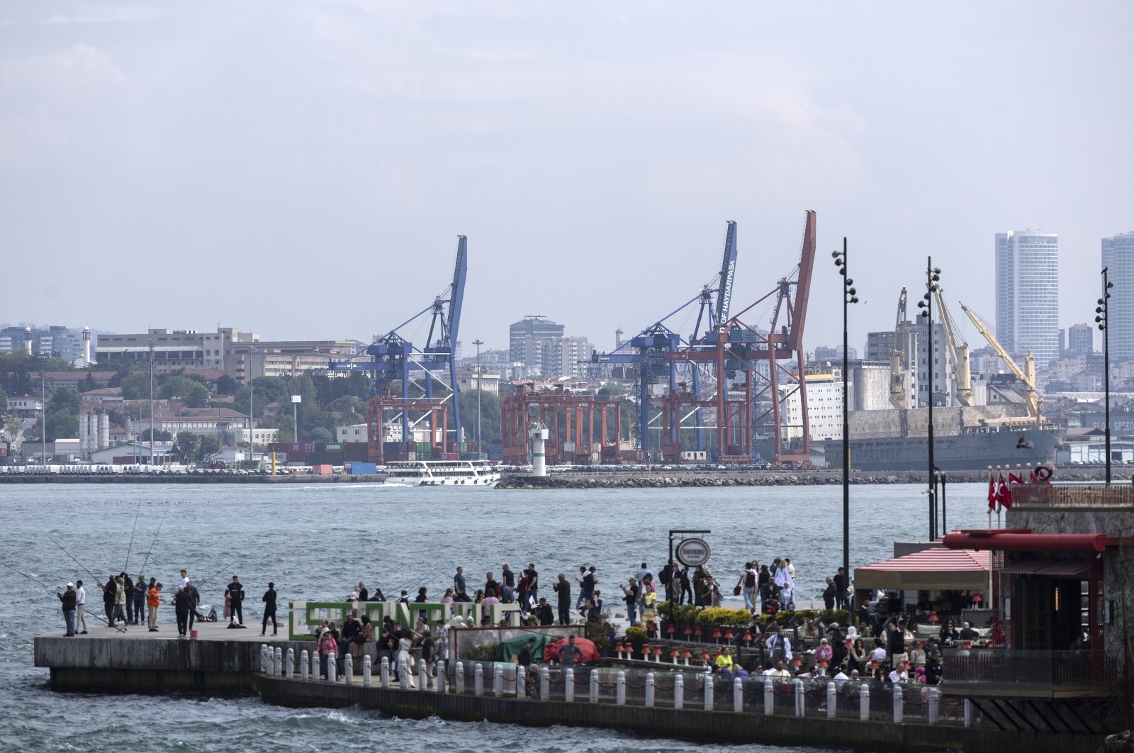 People stand on a pier near the Bosporus near Haydarpaşa Port, Istanbul, Türkiye, May 3, 2024. (EPA Photo)