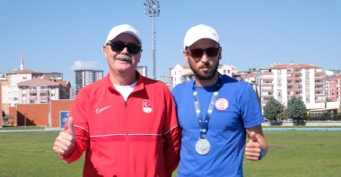 Turkish visually impaired national athlete Oğuz Akbulut (R) poses for a photo with his coach Ertürk Yalmen, Ankara, Türkiye, May 10, 2024. (DHA Photo)
