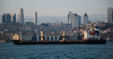A cargo ship passes through the Bosporus with skyscrapers in the background in Istanbul, Türkiye, Jan. 15, 2023. (Reuters Photo)