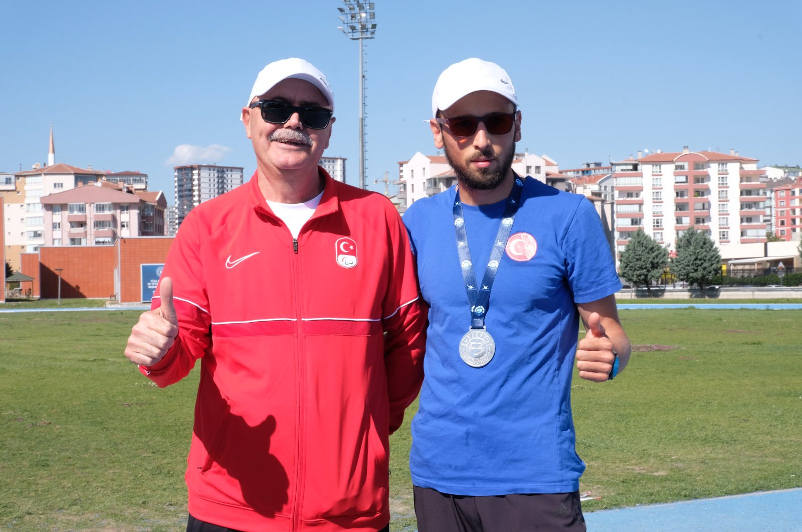 Turkish visually impaired national athlete Oğuz Akbulut (R) poses for a photo with his coach Ertürk Yalmen, Ankara, Türkiye, May 10, 2024. (DHA Photo)