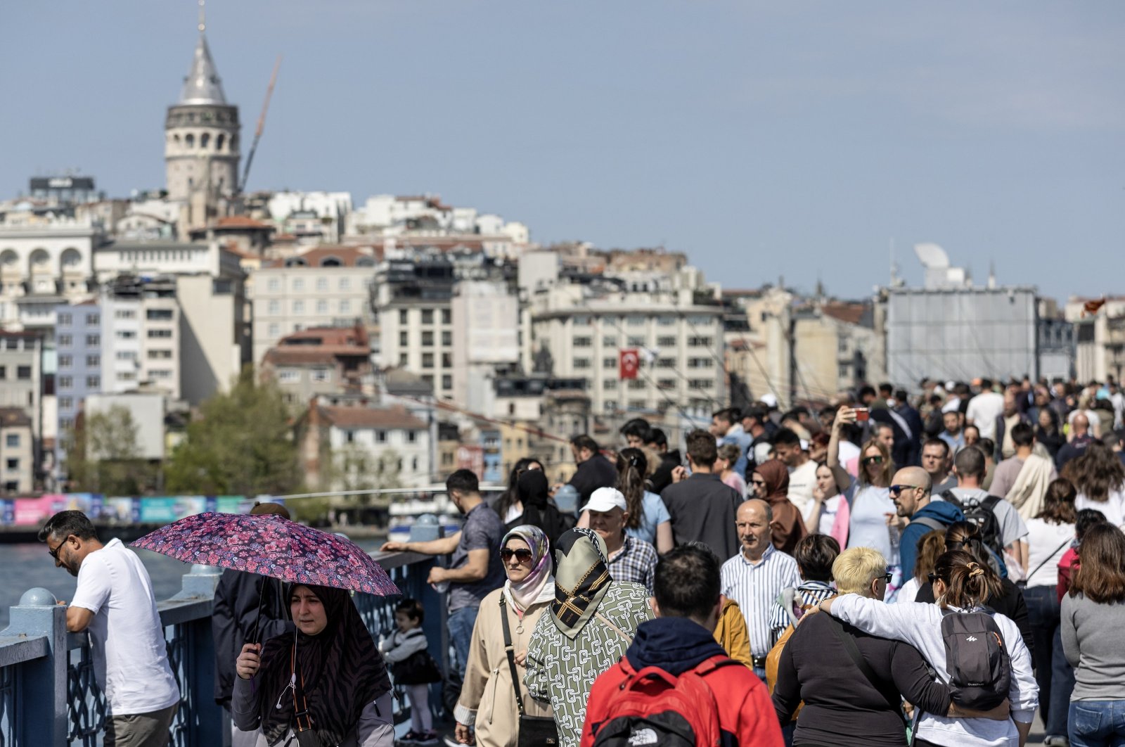 People walk along the Galata Bridge in Istanbul, Türkiye,  April 13, 2024. (EPA Photo)