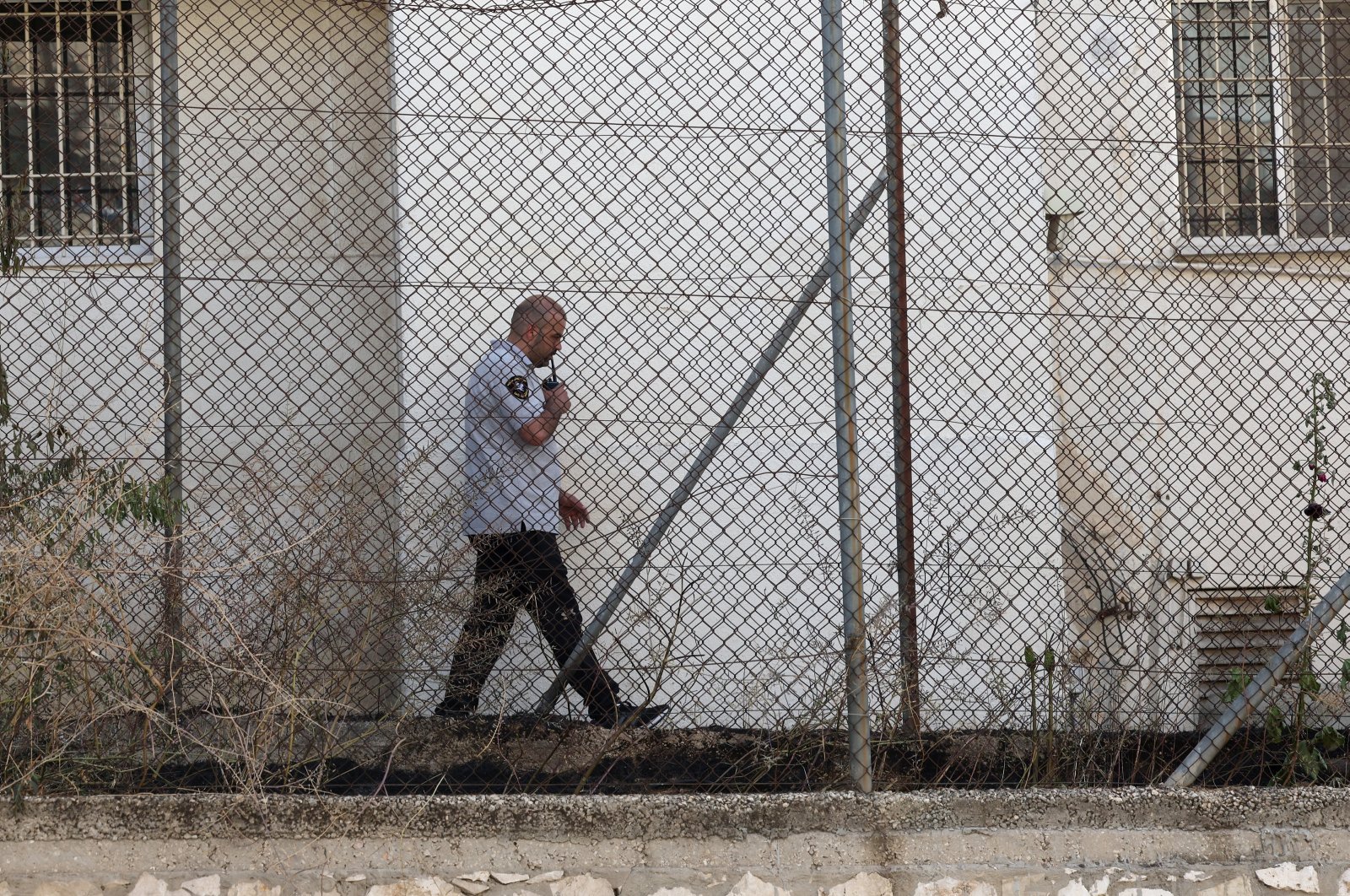 A security guard inspects an area outside the U.N. agency for Palestinian refugees (UNRWA) offices in East Jerusalem, occupied Palestinian territories, May 10, 2024. (EPA Photo)