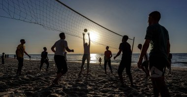 Palestinians play volleyball on a beach in Deir al-Balah in the central Gaza Strip, Palestine, April 17, 2024. (AFP Photo)