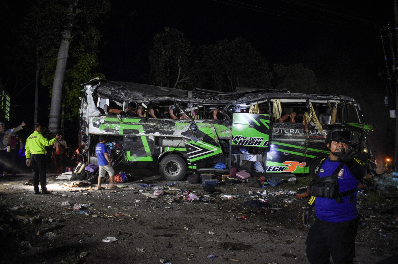 Officers check the debris and belongings of passengers after a bus crash that killed 11 people, in Subang, West Java, Indonesia, May 11, 2024. (AFP Photo)