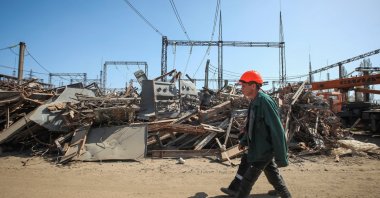 An employee of a critical power infrastructure installation, which was recently hit during a Russian missile strike, walks by its destroyed part, Kharkiv, Ukraine, April 10, 2024. (Reuters Photo)