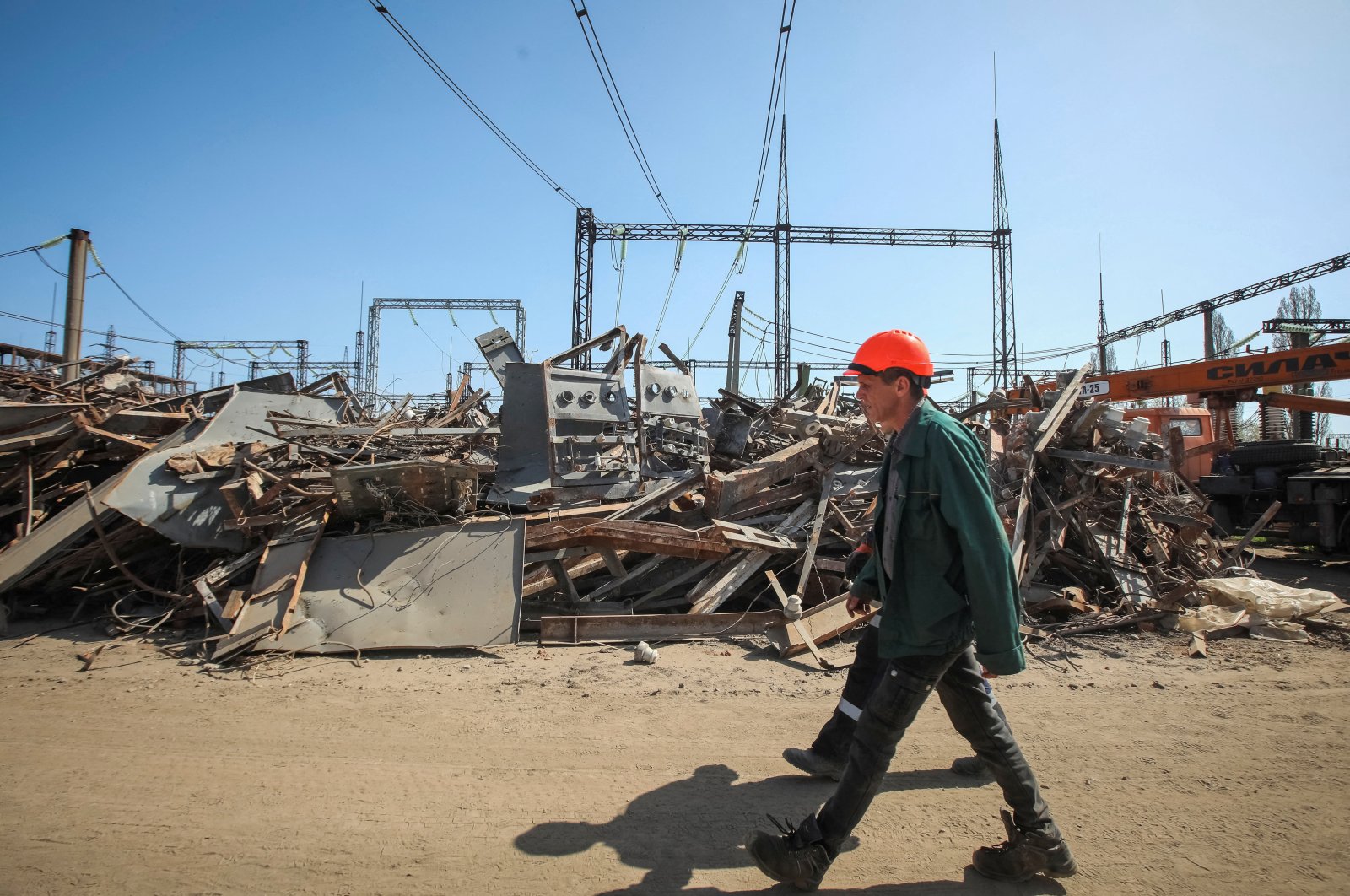 An employee of a critical power infrastructure installation, which was recently hit during a Russian missile strike, walks by its destroyed part, Kharkiv, Ukraine, April 10, 2024. (Reuters Photo)