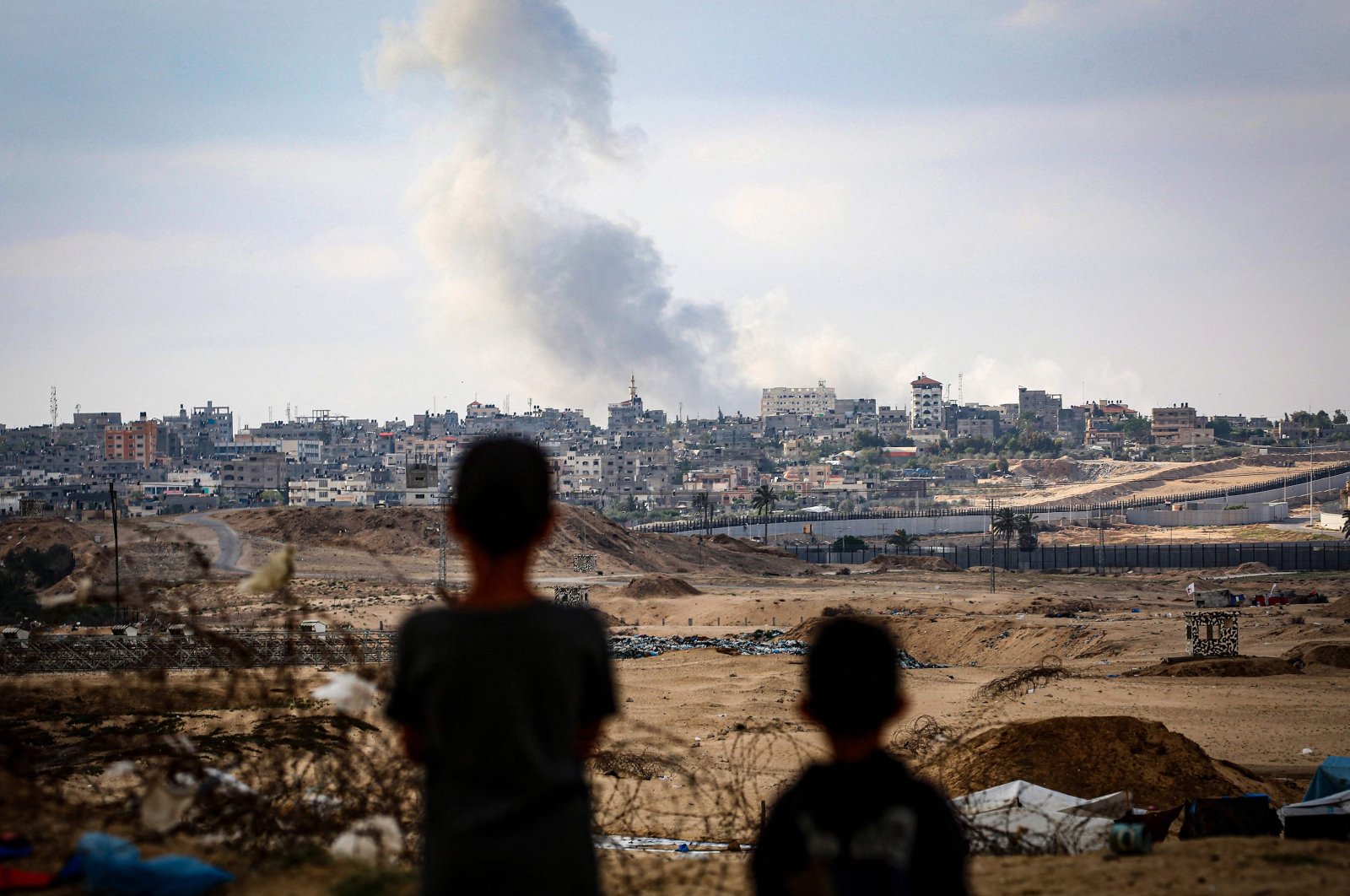 Boys watch smoke billowing during Israeli strikes east of Rafah in the southern Gaza Strip, Palestine, May 13, 2024. (AFP Photo)