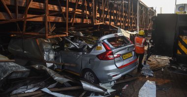 A vehicle is seen crushed under an advertisement billboard that collapsed at a petrol station following a storm, in Mumbai, India, May 14, 2024. (AFP Photo)