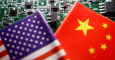 Flags of China and the U.S. are displayed on a printed circuit board with semiconductor chips, in this illustration picture taken Feb. 17, 2023. (Reuters Photo)