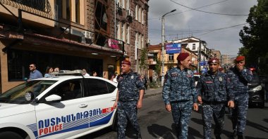 Armenian law enforcement officers watch demonstrators attempting to block a street in a protest against land transfer to neighboring Azerbaijan, in Yerevan, May 13, 2024. (AFP Photo)