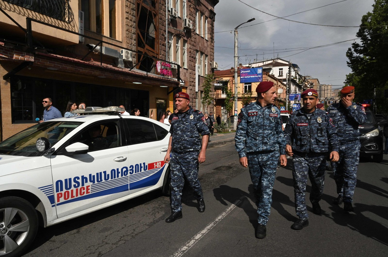 Armenian law enforcement officers watch demonstrators attempting to block a street in a protest against land transfer to neighboring Azerbaijan, in Yerevan, May 13, 2024. (AFP Photo)